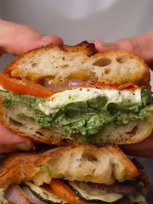 A post by @breadbakebeyond on TikTok caption: Roasted Veggie & Burrata Sandwich Burrata season’s almost here, so I kicked it off with this delicious sandwich. Basil pesto on the bottom, fresh arugula, and roasted veggies. All the perfect match for that creamy burrata. Tucked into a fresh, crispy baguette for the ultimate bite! #easydinner #EasyRecipe #baguette #sandwich #burrata #pesto  Easy recipe Basil pesto Burrata  Veggie sandwich  Roasted veggies 