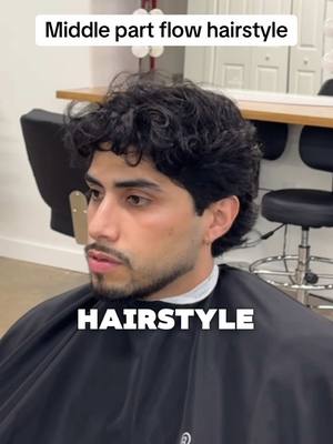 A post by @ivanthegreat86 on TikTok caption: Middle part flow hairstyle 💇🏻‍♂️ #dallasbarber #fortworthbarber #menshairstyle #hairtransformation #wavyhair #curlyhairroutine 