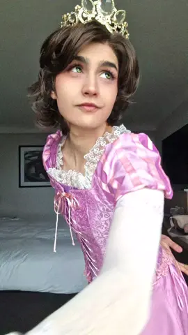 A post by @whatabout4ndy on TikTok caption: It was so lovely meeting everyone at con this weekend. I am so happy to be finally cosplaying a character I wanted to do for years and years and I can't wait to cosplay her again! #rapunzel #rapunzelcosplay #tangled #tangledcosplay 