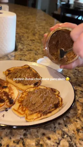 A post by @lil_celery on TikTok caption: wayyyyy too good 🤤 Full recipe for pancakes✨🥞 - 1 cup elevate protein flour (linked in showcase) - 1 cup stevia  - 2 eggs  - 1 tbsp vanilla extract  - 1/4 cup sugar free syrup - 1/2 cup low fat greek yogurt  - 3 tbsp sugar free chocolate chips  #dubaichocolate #proteinpancakes #breakfast 