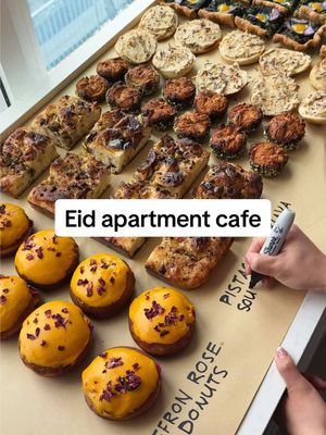 A post by @ryannordheimer on TikTok caption: turning my apartment into a cafe: eid edition ☕️  a HUGE thanks to all these friends who supported this month’s cafe 👨‍🍳 @ryannordheimer - myself, star of the show, donuts, shakshuka @Christine - co-host, focaccia, bagels @zackzico - Eid guest of honor, kenefa @pancakeprincess - atayef @Mei - baklava, ice cream @thedeeperlivingeats - halva tiramisu @danabydana - kouign-amann @irenechung.art - illustrations  @jerumai - videography, @Halle Burns - vibes  saffron rose brioche donuts 🌹 1. In a stand mixer, add 4.5 cups all purpose flour, 1 egg, 2 tsp salt, 1/2 cup sugar, 2 tsp active dry yeast, 1 cup milk, 1/2 cup water. Mix on medium-low for 8 minutes. Then add 1 stick @tillamook butter. Mix for another 8 minutes. Add to a greased bowl. Cover. Let proof overnight (or 1.5 hour at room temp).  2. Turn down out, punch down. Roll into a 10x13 in” rectangle. Punch out 3” circles. Add to two parchment lined baking sheets that have been greased. Cover and let proof 1 hour in a warm spot.  3. Fry 4 donuts at a time in 350F vegetable oil, 2 minutes a side. Transfer to a wire rack.  4. Make pastry cream flavored w rose and saffron.  5. Glaze donuts with a thick powdered sugar icing that has some saffron added to it. Garnish w rose.  . . . . #recipe #viral #apartmentcafe #cafe #aesthetic #coffee #shakshuka #donuts #newyorkfood #donut #nyc #newyork #eid #nyccooking #saffron #nycfoodie #nycfood #nohourscafe #eastvillage #brunch #ryannordheimer #arabfood #persianfood #eidmubarak #rose #spring #springfood #doughnut