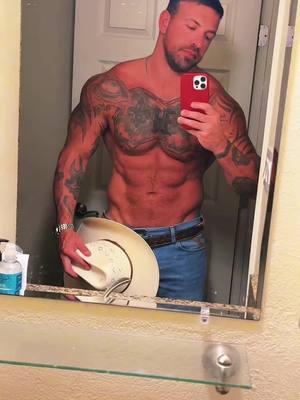 A post by @nottattedfire on TikTok caption: Humpday #cowboy #muscle #wrangler #tattoos #BookTok #abs #model 