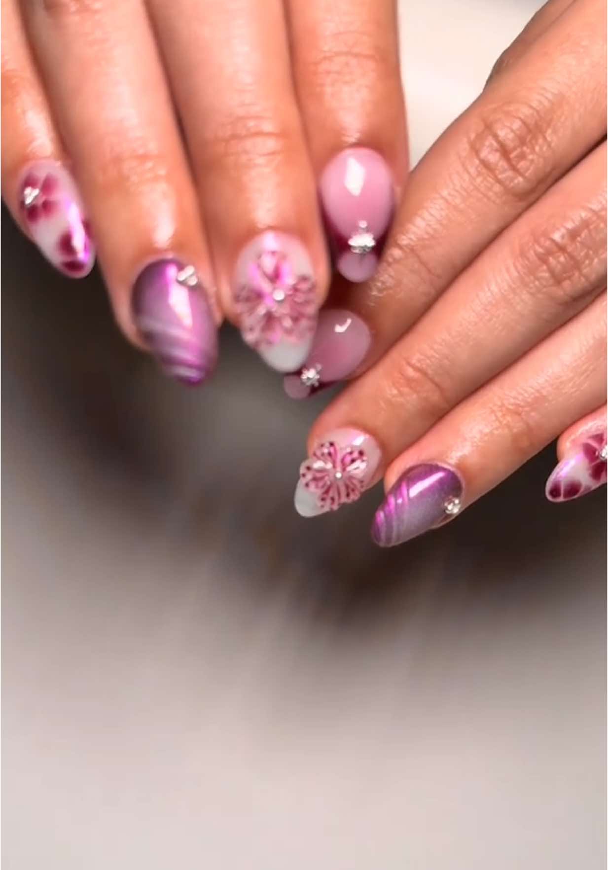 A post by @_nailzbymariah_ on TikTok caption: Prettiest birthday set!  #nailzbymariah #goodyearnailtech #aznails #athomenailtech #explorepage #fyp #vbeautypure #beetlesgelpolish #kupatopcoat #nailsandblinks #frenchtipnails #auranails #chromenails #3dflowernails #bloomingglnails #birthdaynails 