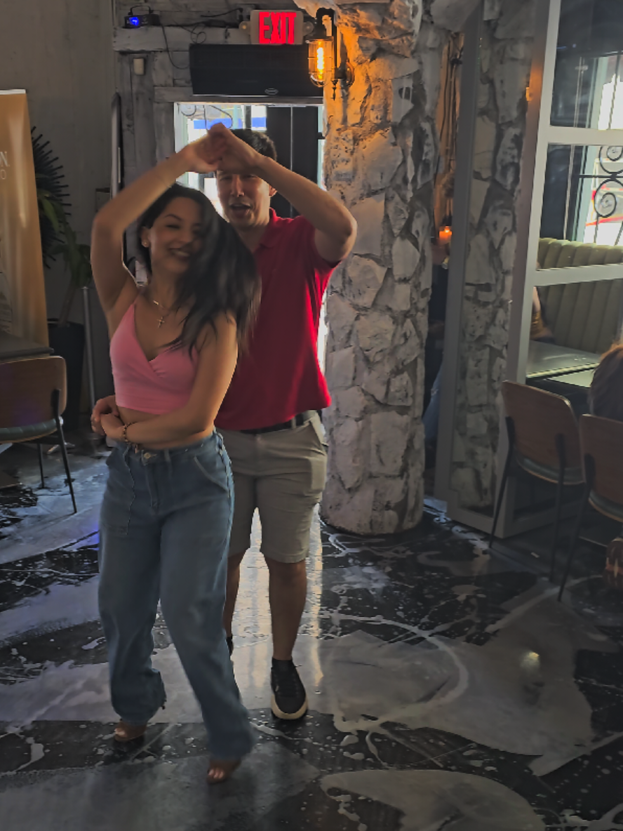A post by @ritmoconson on TikTok caption: Dancing with this talented dancer @jailine.b at @fabians_htx  Brunchateame  event taking place every sunday and teasing the camara guys with his signature sign @brasil911