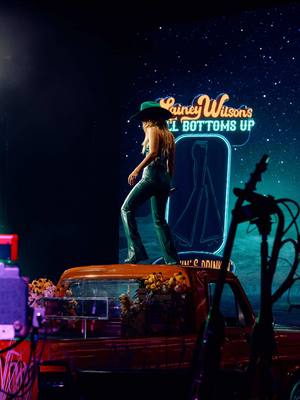 A post by @laineywilson on TikTok caption: Years ago, I always said if I could have a bar on Broadway, I would call it Bell Bottoms Up. Well, here’s the theme song! 🔔👖🩵  #NationalBellBottomsDay #BellBottomsUp 