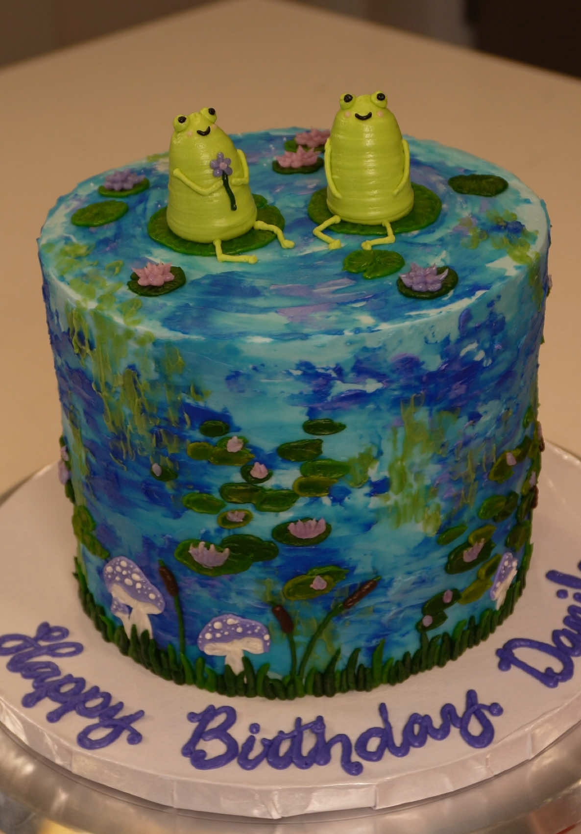 A post by @savsgotcake on TikTok caption: Frog lily pad cake🐸🪷💜🎨  #cakedecorating #cakedecorator #paintedcake #frogcake #lilypad #birthdaycake #cakeideas #claudemonet #waterlilies #cake 
