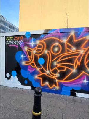 A post by @fatcapsprays on TikTok caption: Who can name this one flopping around Kingston? 🐠 Thanks to @theroyalboroughofstreetart for inviting me down to paint the spot!  • • • • • #streetart #streetartist #streetartlover #streetartlovers #streetartaddicted #streetarteverywhere #streetartchat #streetartistry #urbanartist #Art #fatcapsprays #neonart #spraypaint #muralpainting #publicart #graffiti #graffitiartist #cartoon #popart #handpainted #asmr #asmrart #satisfying #oddlysatisfying #processvideo #artprocess #artprocessvideo #streetartlondon #pokemon #neon #neonart