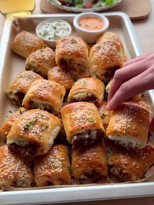 A post by @kookmutsjes on TikTok caption: PUFF PASTRIES WITH GROUND BEEF AND RICOTTA #food #recipe #pastry #puff #beef #ricotta #easy #fy #fyp GROUND BEEF MIXTURE 25 ml olive oil 140 g yellow onion (1 yellow onion) 350 g ground beef 10 g fresh parsley 4 g salt (⅔ teaspoon) 3 g cumin powder (1 teaspoon) 3 g garlic powder (1 teaspoon) 3 g cayenne pepper (1 teaspoon) 2 g black pepper (⅔ teaspoon) 1 g Italian seasoning 30 g tomato paste 75 ml water RICOTTA MIXTURE 250 g ricotta 10 g fresh chives 1 g black pepper (⅓ teaspoon) WRAPPING 540 g fresh puff pastry (2 rolls) EXTRA grated cheese TOPPING 1 egg (medium) sesame seeds Heat the olive oil in a frying pan over medium heat. Add the chopped onion and sauté for 3–4 minutes.  Add the minced meat along with the finely chopped parsley, salt, cumin, garlic powder, cayenne powder, black pepper, and Italian seasoning. Cook for 6–7 minutes, breaking the meat apart as it cooks. Add the tomato paste and water. Let it simmer for another 2–3 minutes. Remove from the heat and let the meat mixture cool completely. Meanwhile, in a bowl, mix the ricotta with the finely chopped chives and black pepper. Set aside. Roll out the puff pastry and cut each sheet in half. This depends on the size of your puff pastry. Mine was big, so cutting it in half made the following process easier. Spread the ricotta mixture lengthwise in a strip over the pastry. Spoon the meat mixture on top and sprinkle some grated cheese over it. Roll up tightly.  Repeat this with the remaining puff pastry. Cut the filled pastry rolls into pieces as desired. Place the pastry bites on a baking tray lined with parchment paper. Brush with beaten egg and sprinkle with sesame seeds. Place the pastry bites in a preheated oven at 190°C (top and bottom heat). Bake for 25–30 minutes, or until golden brown. Tips: Let the meat mixture cool completely before placing it on the pastry. Warm meat will make the pastry soggy and harder to roll. Work on a cool surface to prevent the puff pastry from softening too quickly. Besides grated cheese, you can also use mozzarella for extra stretchy bites. If preparing in advance, store unbaked in the fridge, and only brush with egg right before baking. Prefer milder spices? Replace cayenne pepper with paprika. You can freeze the bites unbaked. Just add 5–10 minutes to the baking time.