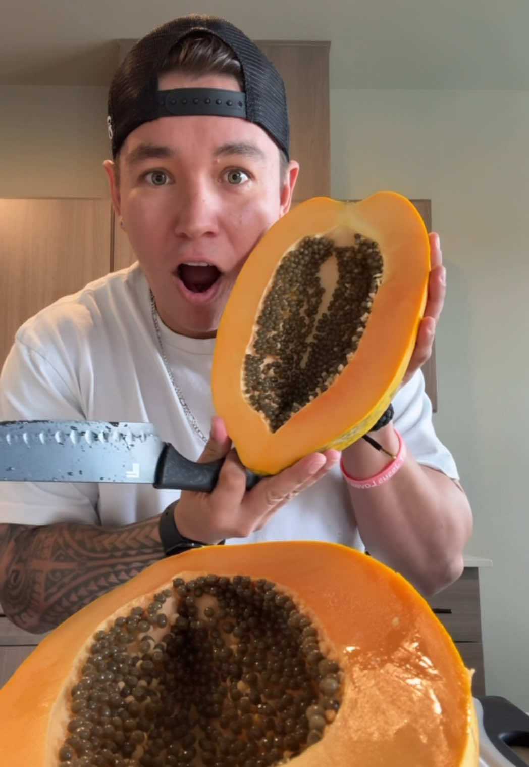 A post by @jonnytsunami808 on TikTok caption: I got the biggest papaya in the world?! 😳🌍