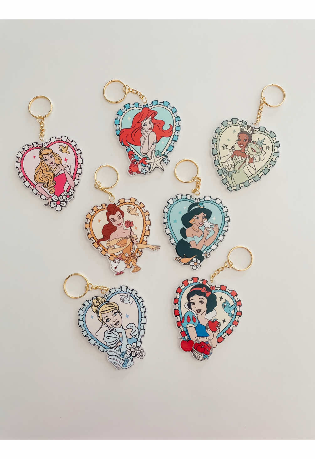 A post by @threepairsofears on TikTok caption: Make some acrylic princess keychains with me! 👑✨ … #threepairsofears #smallshop #smallbusiness #craftlaser #craftroom #crafts #craft #crafting #diy  #xtool #xtoolp2 #uvdtf #keychain #acrlyic #princess #disneyprincess   