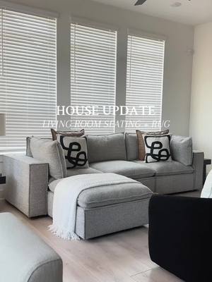 A post by @trutolyss on TikTok caption: Let’s get into the living room seating ✨ yall, I need those curtains up ASAP but we’re not here for that, so let’s focus. Alright so, lots of questions about our sofa. She’s not white, shocked? So am I! But I fell in love with this @roomstogo sofa with an ottoman. This is the Langford Park 4pc with an Ottoman - she’s gorgeous 🖤 So with my living room setup, I needed to close off the space and we did that using two swivel chairs and an end table from @Wayfair  Last but not least, what’s a room without an @amazonhome find - this 9x12 cream color rug, brought the space together and she’s perfect! Let me know what you think down below 🖤 Everything is linked on my @shopltk  #fromhouse2homewithlyss #livingroomdetails #amazonhomefinds #wayfairhome #cozylivingroom