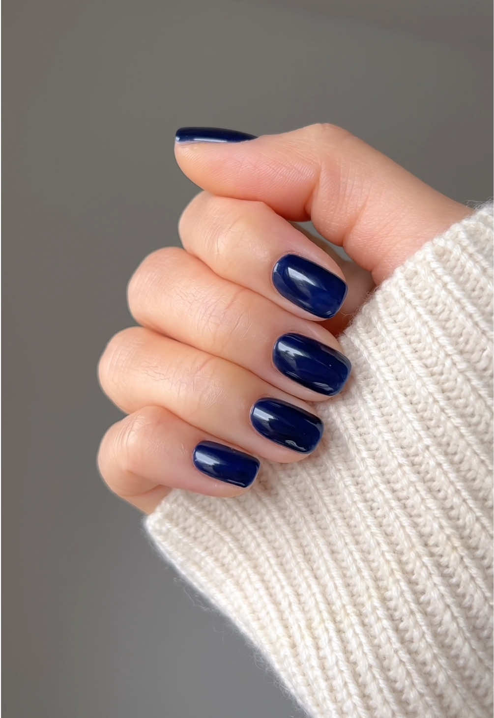 A post by @nailsbyalsn on TikTok caption: it’s spring but the cold is making me miss my darker shades 🫠 Using @GELCARE®  Sapphire  Top Coat * discount code: NAILSBYALSN @Grown Alchemist restorative hand cream #bluenails #nailinspo #swatch #summernails 