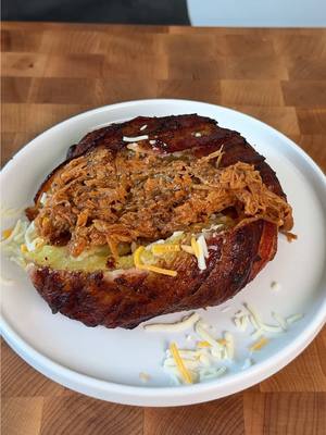 A post by @fooddudescook on TikTok caption: Loaded BBQ Bacon-Wrapped Baked Potatoes 🥔 #easyrecipe #cooking #recipes