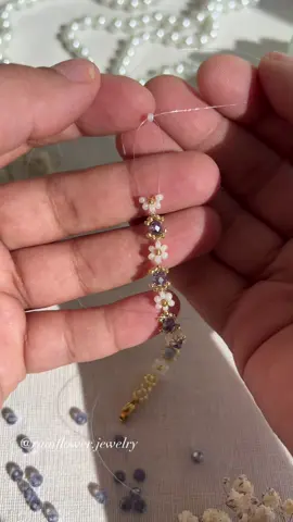 A post by @rainflower.jewelry on TikTok caption: Can’t believe I waited this long to make a bracelet with purple stones! This floral set with a gorgeous violet stones is finally here — now available in my shop with free worldwide shipping💜💫Link in bio! #purplebracelet #beadedjewelry #floralbracelet #handmadewithlove #aestheticvibes #springstyle #daintylayers #jewelrytok #smallbiztok #bohoaccessories #fyp #supportcreators #freeworldwideshipping #uniquedesign #trendingnow #bracelettok #daisybracelet 