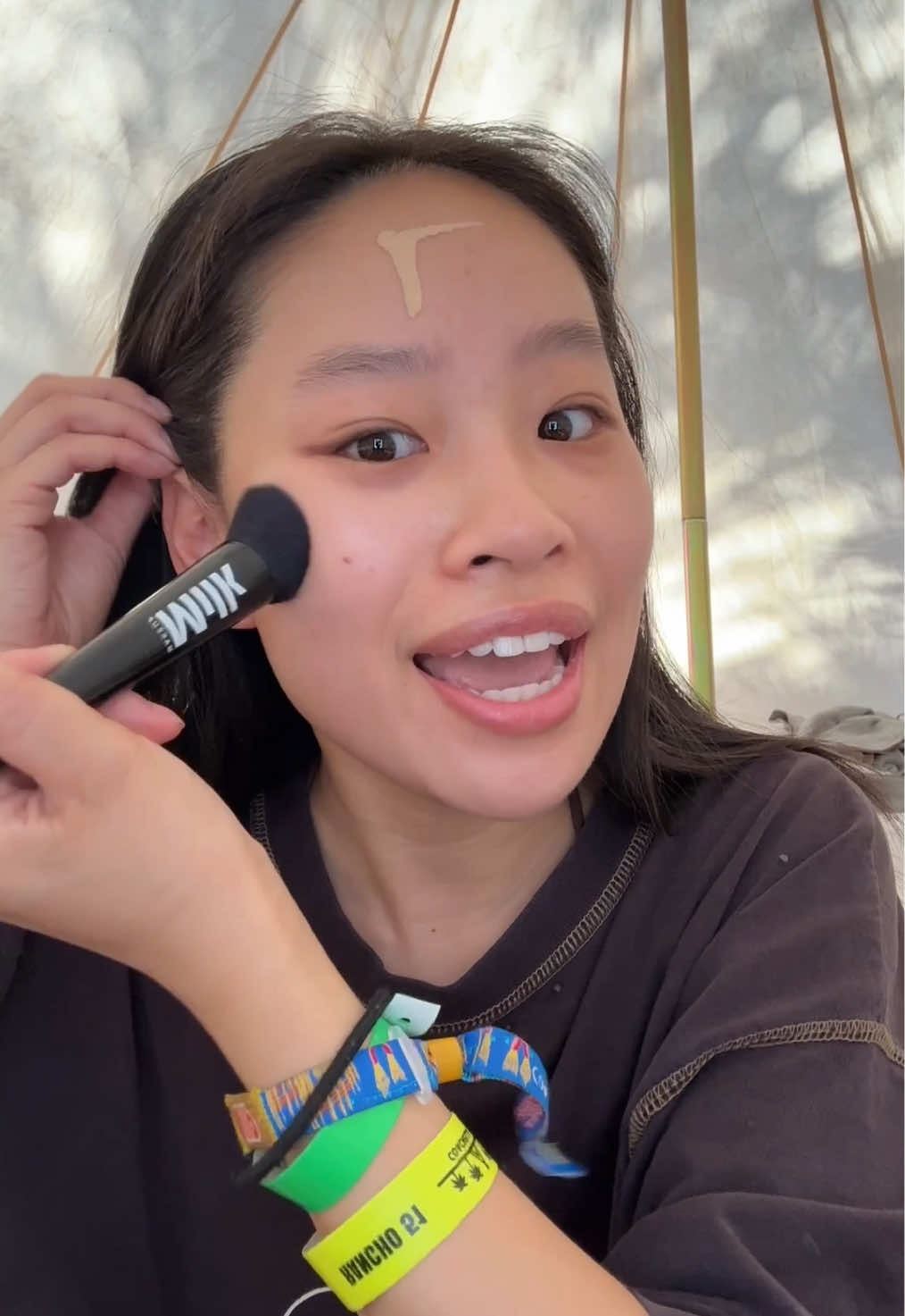 A post by @lizzymwong on TikTok caption: I was this close 🤏to going home for the last day of Coachella 😓 #grwm #festivalmakeup #coachellamakeup #coachella #smokeyeye #rhinestonemakeup #easymakeup 