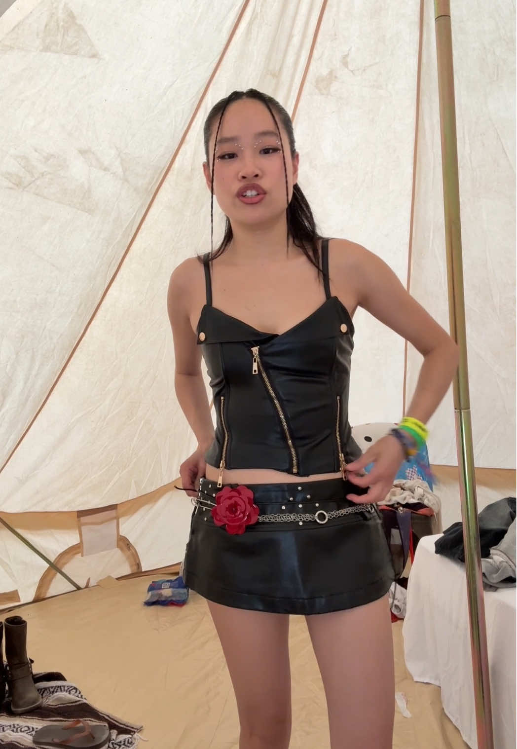 A post by @lizzymwong on TikTok caption: I may be miserable from the heat but at least I feel good about my outfit  #grwm #festivaloutfit #coachellaoutfit #coachella #musicfestival #leatheroutfit 