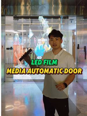 A post by @filmbase_smartfilm_leo on TikTok caption: Do you want to have the same transparent display automatic door? #ledglass #leddisplay #ledscreen #displayglass #ledfilm #transparentdisplay #ledscreen #3ddisplay #glassdisplay #filmbaseleo 