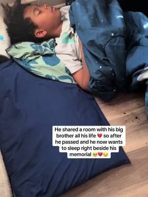 A post by @ree5ree on TikTok caption: Before yall come for me yes he has his own bed and yes he rather sleep right here on the floor next to his brother 🥺😔💔 #grief #griefjourney #grievingmom #childloss #griefjourney💔 #grievingjourney #grievingmother #foreverzack 