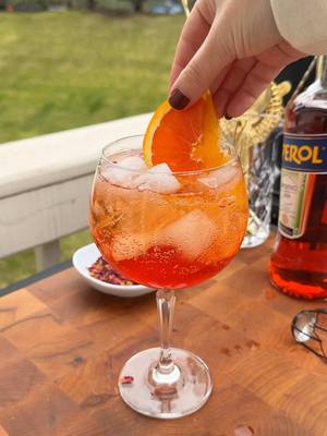 A post by @kristenfaith_eats on TikTok caption: Strawberry Hibiscus Aperol Spritz 🍊🍹🍓 #aperolspritz #spritz #spritzrecipe #hibiscus #strawberrydrink #yum #fyp #drinkrecipes 