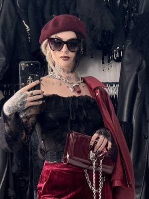 A post by @izzysiim on TikTok caption: Red and black is the most perfect combo 🥀🖤  Top @LOVE TOO TRUE  Trousers @Vinted  Belt @Primark  Boots @Dr. Martens  Bag @meltcosmetics  Beret charity shop Sunglasses @KILLSTAR  Necklace @⛓️ LOVE ROKZ ⛓️  Jacket @asos  #altfashionoutfit #alternativegirl #alternative #gothfasion #goth #springoutfitideas