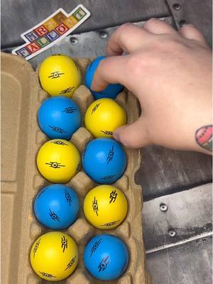 A post by @mrs.fallout on TikTok caption: Crafting the Fallout Easter eggs for the hunt! The eggs were from Walmart (This one was easy just drew Vault-tec symbols on and added the goodies inside!) #fallout #fallouttok #mrsfallout 