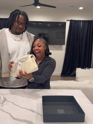 A post by @shdayandmal on TikTok caption: Just when she thought it was over… I pulled out a second bag. Her reaction? Priceless.🤣❤️ #couple #shdayandmal #fyp #trending #vlog #coachpurse #suprise 