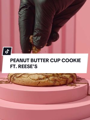 A post by @crumbl on TikTok caption: It’s a fan favorite for a reason. 😍 Drop a 🥜 if you’re excited to see Peanut Butter Cup Cookie ft. REESE’S again! #Crumbl 
