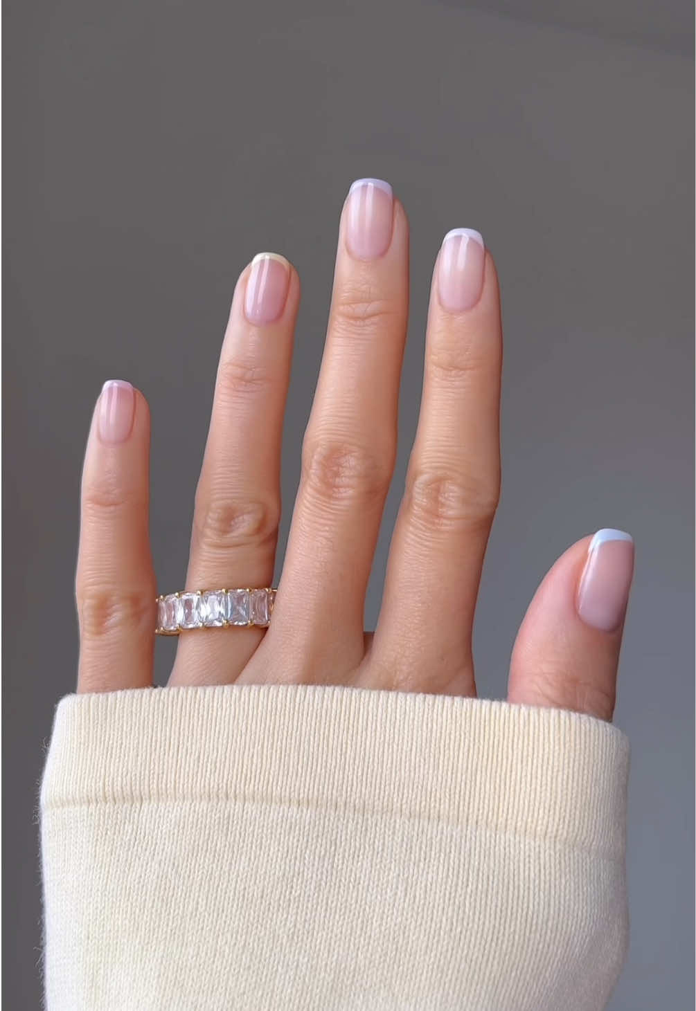 A post by @nailsbyalsn on TikTok caption: spring nail refresh asmr and yes i went waaaay shorter 🐰🌸💛 Using @GELCARE®  Cuticle Softener Nude Bb Creme Kawaii Blue Hibiscus Latte Desaturated Purple Butter Manoir Pink * discount code: NAILSBYALSN @Soft Services theraplush repair treatment *aff #pastelnails #springnails #nailinspo 