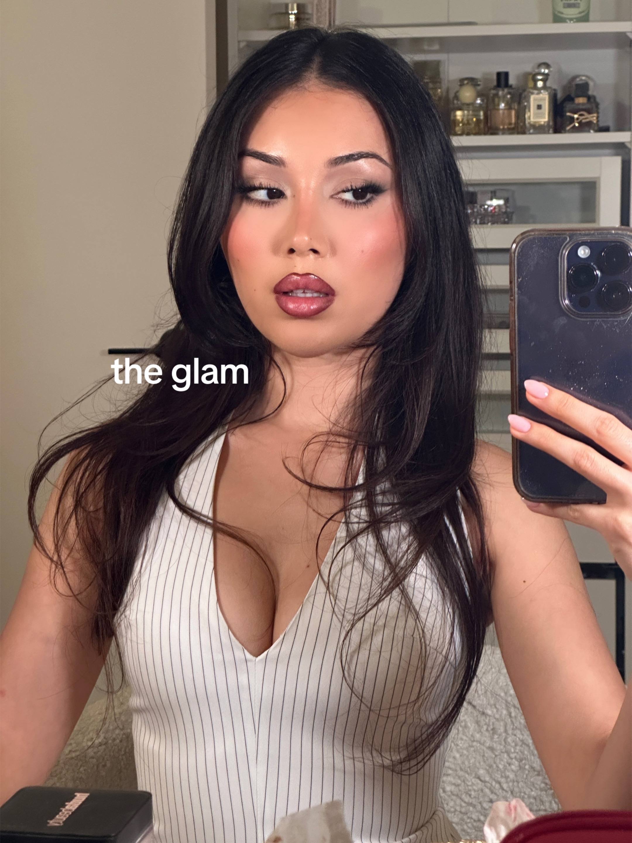 A post by @nazliayunus on TikTok caption: the glam vs the outfit - a cherry cola lip moment 🍒🥤💋 #cherrycolalips #lipcombo #outfitinspo #makeuplooks #makeuplook #eyeshadowlook #outfitideas 