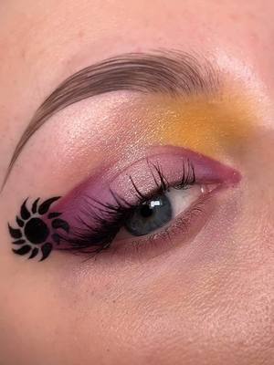 A post by @colourpopco on TikTok caption: Freaking out over this Tangled-inspired look by @India ☀️🏰🌸  Wearing the NEW Disney Tangled by ColourPop eyeshadow palette. 💜💫 Featuring 12 sparkling, royal shades inspired by the iconic Disney film. 🎨 Available now on TikTok Shop. 🛍️