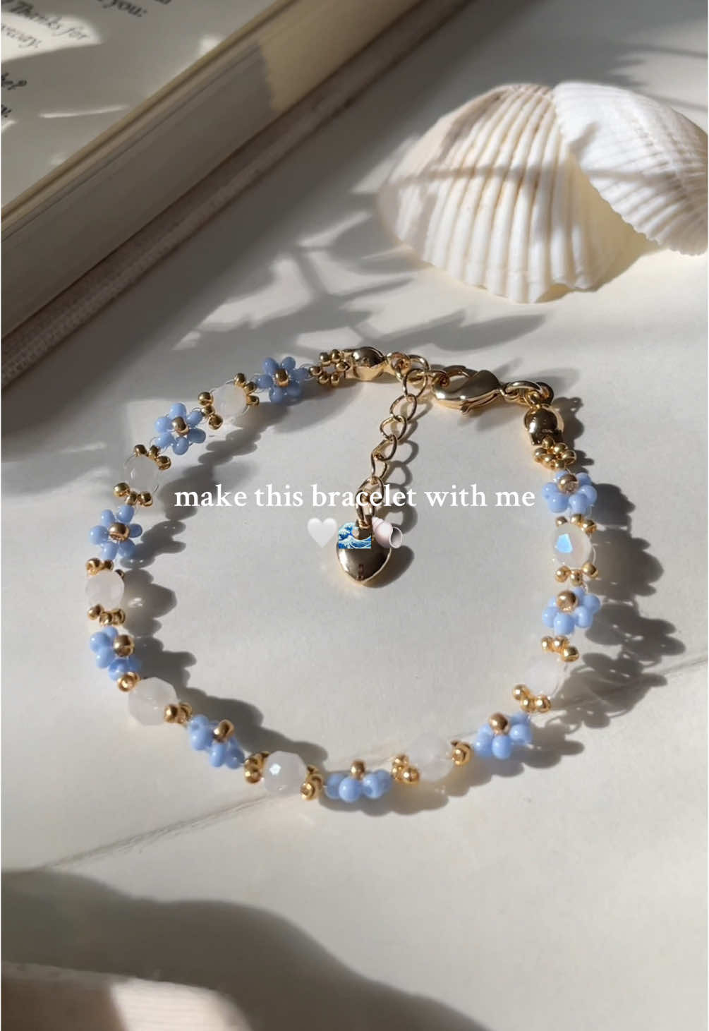A post by @bijouxlasotita on TikTok caption: Summer, beach day, inspired bracelet✨🤍🌊☀️🐚 #SmallBusiness #handmadejewelry #handmadejewelrybusiness #beadedjewelry #canadiansmallbusiness 