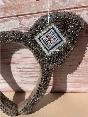 A post by @greatwolflodge on TikTok caption: Shoutout to @Becca✨Bedazzle rhinestone art for turning our classic Wolf Ears and MagiQuest wand into full-on statement pieces! These custom creations aren’t available at any lodge, they’re just a little exclusive magic between us and Becca. Which one would you pick? #greatwolflodge