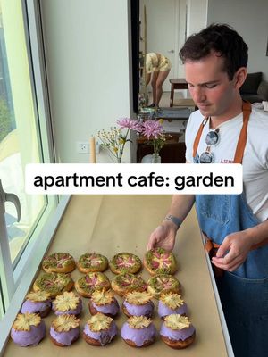 A post by @ryannordheimer on TikTok caption: turning my apartment into a cafe pt 2: garden party 🌷  this could not be accomplished without these wonderful souls 👨‍🍳please follow them all:  @jeremy @scheckeats! - gifts from Spain/Ithaca @Alex G-lilypcrumbs - pistachio cakes, lemon tarts @Christine - ramp focaccia, sourdough pbj, co host @Rach - cottage cake, rock cake @maya - half marathon, zucchini cakes  @pancakeprincess - carrot cake @Deepika Kalla - rhubarb cups @zack.Zico - fig tart @DrinkRipples - latte art machine @Rosemary Home - plates, glasses, candle holders @Brightland - olive oil goodie bags RECIPE 👨‍🍳 lavender pineapple brioche donuts 🌸🍍 1. In a stand mixer, add 4.5 cups all purpose flour, 1 egg, 2 tsp salt, 1/2 cup sugar, 2 tsp active dry yeast, 1 cup milk, 1/2 cup water. Mix on medium-low for 8 minutes. Then add 1 stick @tillamook butter. Mix for another 8 minutes. Add to a greased bowl. Cover. Let proof overnight (or 1.5 hour at room temp).  2. Turn down out, punch down. Roll into a 10x13 in” rectangle. Punch out 3” circles. Add to two parchment lined baking sheets that have been greased. Cover and let proof 1 hour in a warm spot.  3. Fry 4 donuts at a time in 350F vegetable oil, 2 minutes a side. Transfer to a wire rack.  4. In a medium pot, whisk 2/3 cup sugar with 1/2 cup cornstarch. Then whisk in 9 egg yolks. Then 3 cups milk, 1 tsp salt. Whisk over medium heat until very thick. Stir in 4 tbsp butter, 1 tsp vanilla, lavender extract to taste. Chill completely.  5. Fill donuts. Then glaze donuts with a thick powdered sugar icing that has some lavender added to it. Garnish w pineapple that you dried out in the oven at 200F for like 3 hours.  . . . . #recipe #viral #apartmentcafe #cafe #aesthetic #coffee #flower #brioche #newyorkfood #donut #nyc #newyork #garden #nyccooking #gardenparty #nycfoodie #nycfood #rhubarb #eastvillage #brunch #ryannordheimer #danish #springdessert #spring #springideas #brunch #springfood #doughnut