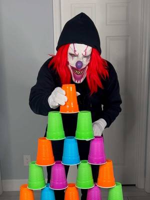 A post by @yoeslan on TikTok caption: Monster helps clown build tower of cups 🤡👻 #funnyvideo #monsterundermybed 
