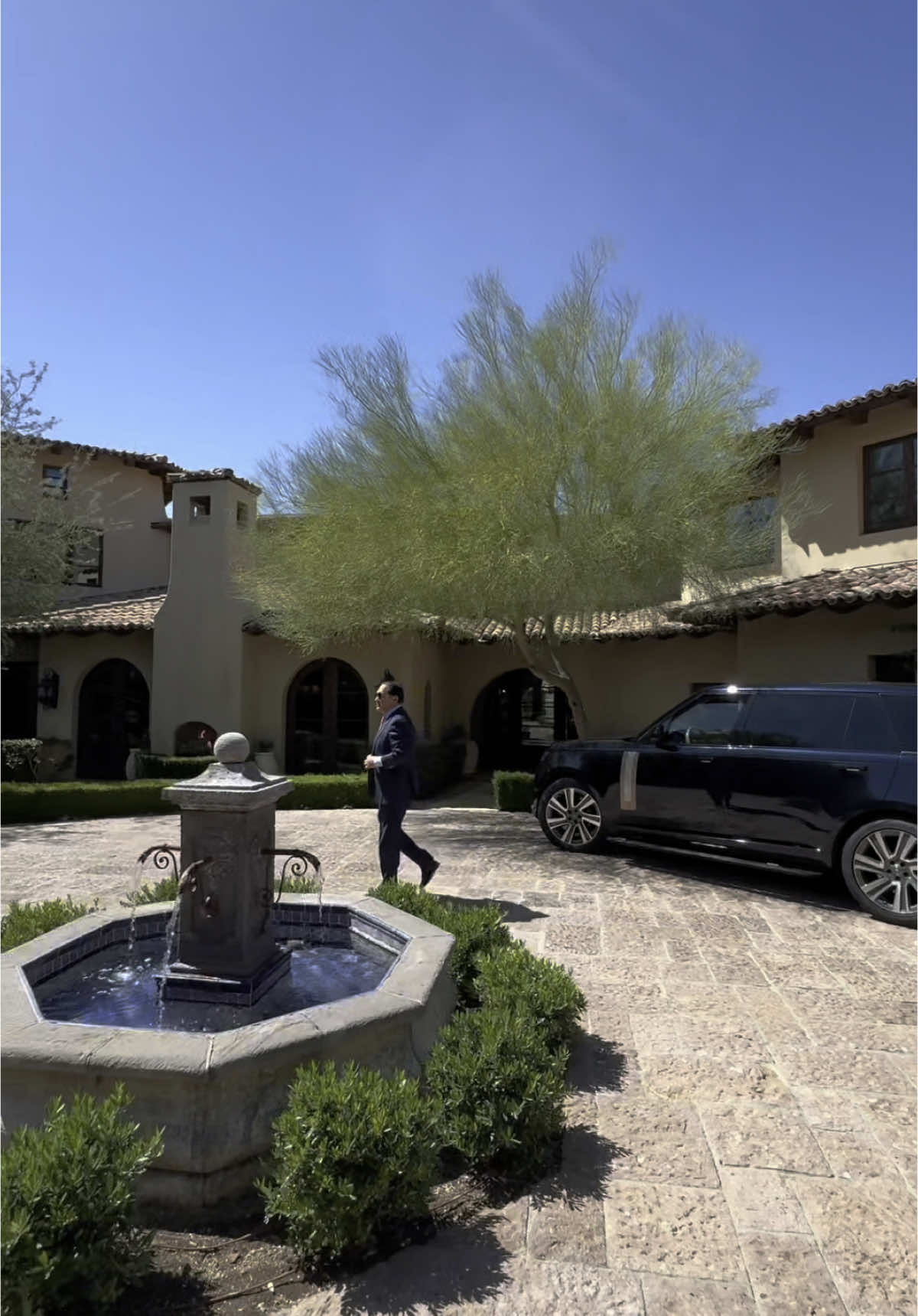 A post by @luxlistings on TikTok caption: Listed at $18,900,000, this 13,961 sq ft estate at 10719 E Rimrock Drive offers timeless architecture, panoramic mountain views, and a full geothermal system — all tucked inside Scottsdale’s most prestigious gated community. Represented by Frank Azaami of @Sotheby’s International Realty  🎥: @luxury_listings  Would you entertain under the stars or escape to the mountainside spa first?