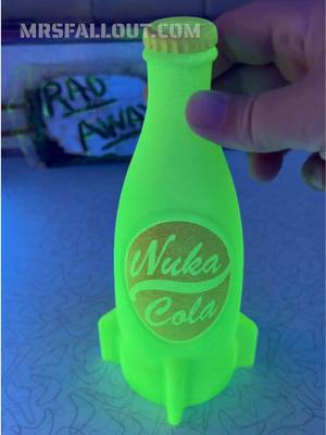 A post by @mrs.fallout on TikTok caption: Making a glowing Nuka Cola Bottle with just some glow in the dark paint. Blacklight really bring out the color but even just charging it up with bright light works great too #fallout #crafting #mrsfallout #fallouttok 