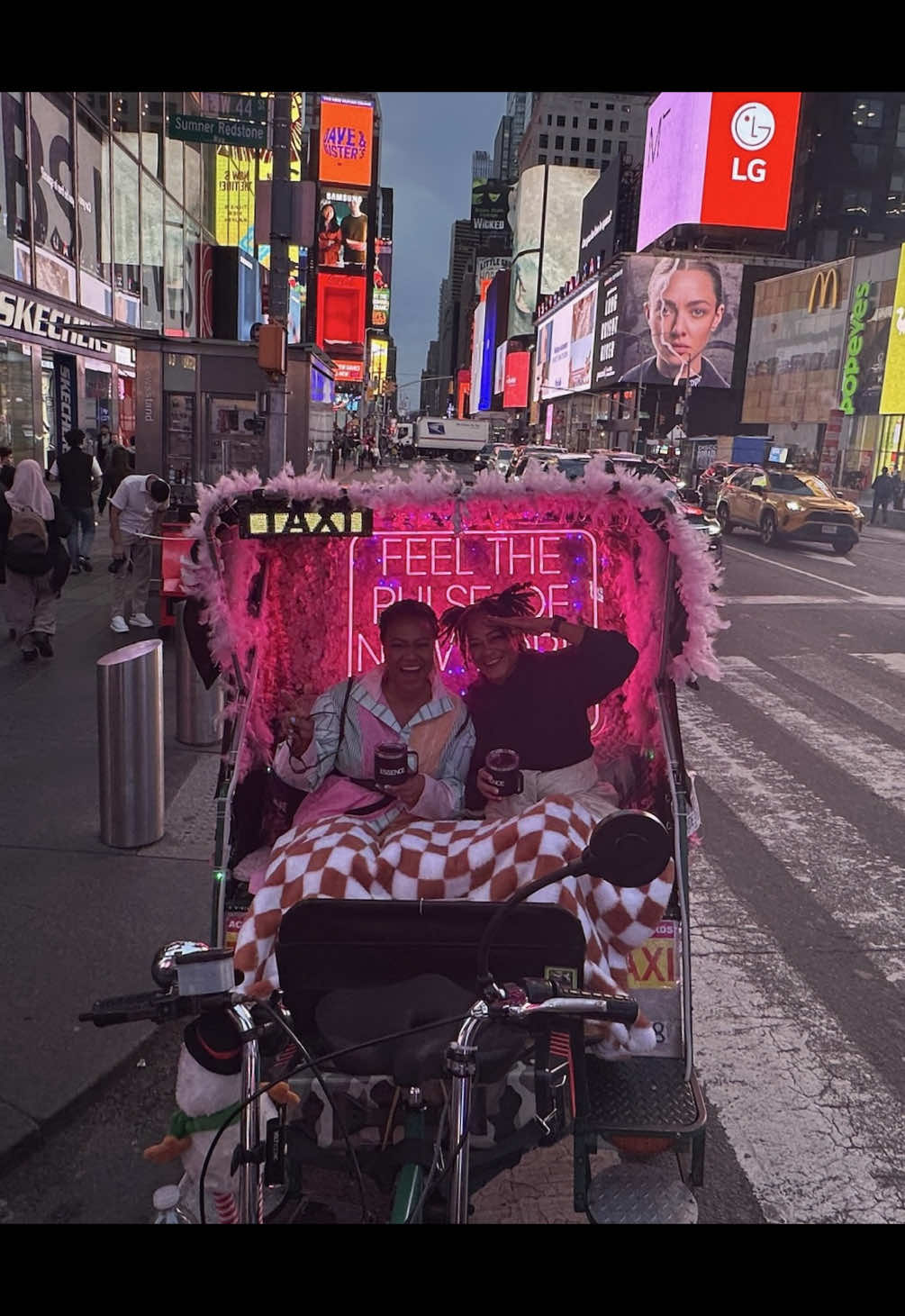 A post by @tatyanaalitv on TikTok caption: *fancy accent* En route to the theatre to see the play that marks Phylicia Rashad’s directorial debut, @Alexia Clincy & I chose a fine pinot noir to sip out of Essence coffee mugs --filled to the brim of course. Yes, the neon sign behind us rang true, we indeed felt the pulse of New York 😅