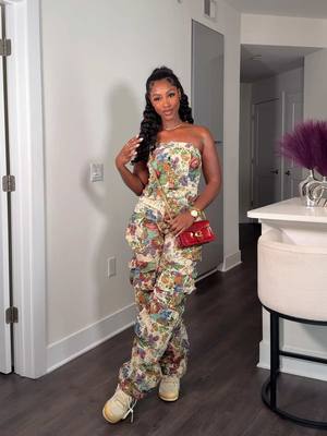A post by @caittheegreat__ on TikTok caption: 🌸Floral Jumpsuit🌸 This cargo jumpsuit is so pretty😍! I saw this on the site and immediately added it to my cart🛒 You can dress this up with heels or down with sneakers like I did 🤭 • Jumpsuit in my LTK Shop, linked in bio ❤️