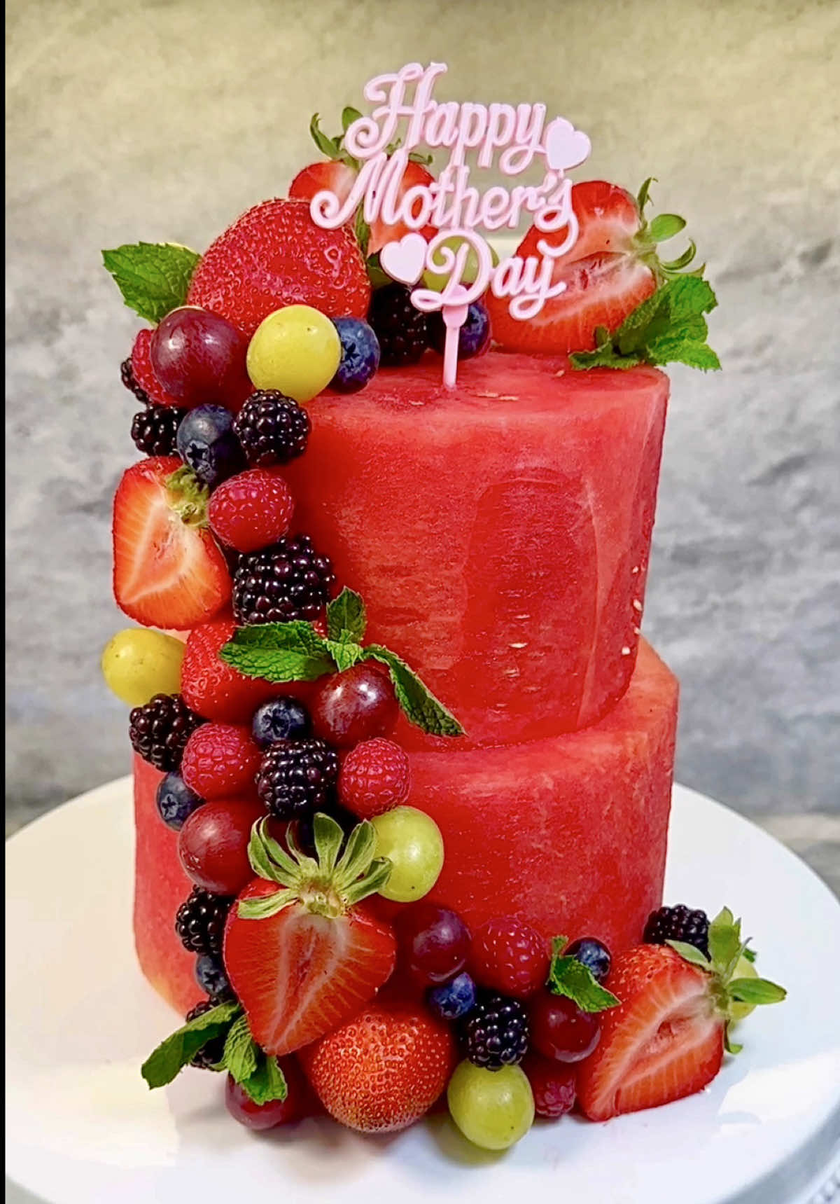 A post by @chefgenevieve on TikTok caption: Send this to someone who loves watermelon 🍉😍 #watermelon #watermeloncake #fruitart #SummerRecipes #mothersday