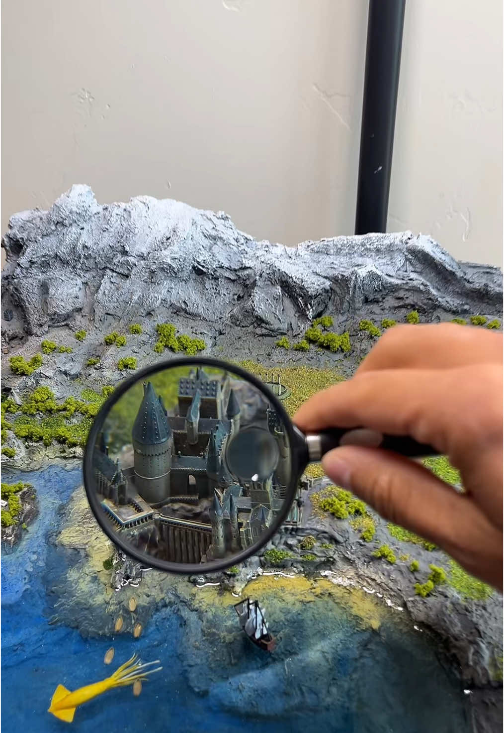 A post by @christopherclaflin on TikTok caption: I just built a whole diorama so I could show off this cloak. 🥺 #cloak #harrypotter #hogwarts #knights #gnomes #wizards