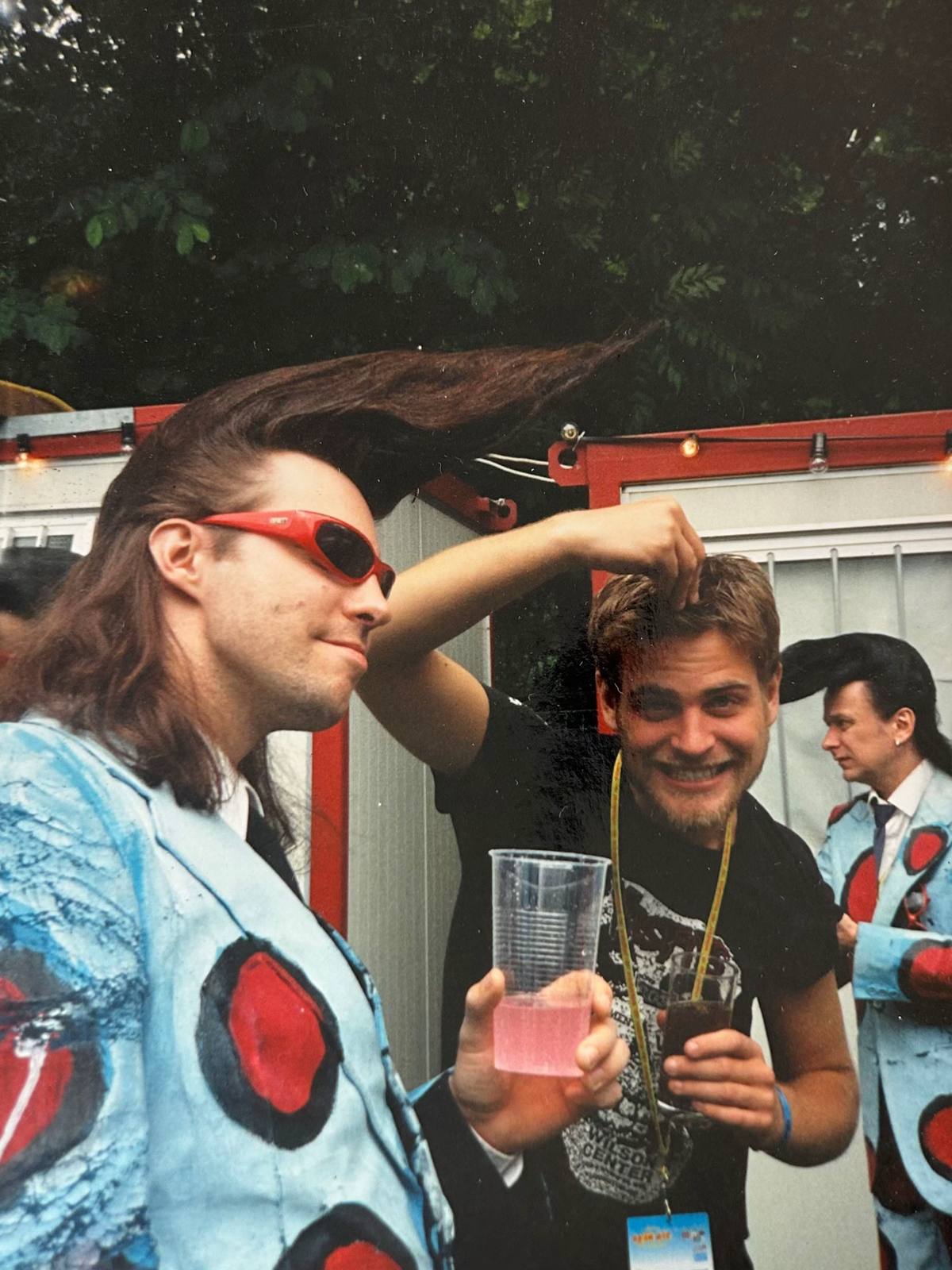A post by @thecardigans on TikTok caption: We (Peter) ran into The Leningrad Cowboys at a festival backstage area. Could well be 1997 somewhere in Central Europe. Were they Finnish by the way? ❤️