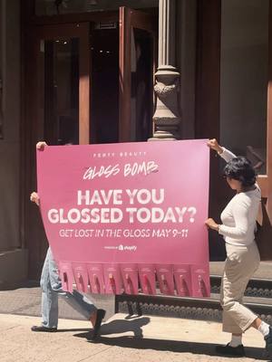 A post by @fentybeauty on TikTok caption: Have you glossed today? 💖 Peep our posters & grab a gloss! 💋 It's t-minus 2 days 'til the Gloss Bomb Shop powered by @Shopify *officially* opens in the heart of SoHo! 🗽 What: ✨ Giant, interactive Gloss Bomb stations 💝 Exclusive freebies + gifts with purchase 🚕 Dripped out, shimmery Gloss Bomb-inspired cabs 🍇 Grape Splash, an exclusive NEW Gloss Bomb shade When: May 9 - 11 from 11 AM - 6 PM Where: Shopify NY, 131 Greene St. New York, NY 10012 RSVP at the glossbombshop.com to get lost in the gloss, besties! 💌