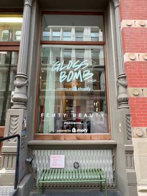 A post by @fentybeauty on TikTok caption: Prep your pout for the Gloss Bomb Shop powered by @Shopify 💖 Only 2 more days 'til this Fenty Beauty function opens in the heart of SoHo! 💅🏽💅🏿💅🏻  What: ✨ Giant, interactive Gloss Bomb stations 💝 Exclusive freebies + gifts with purchase 🚕 Dripped out, shimmery Gloss Bomb-inspired cabs 🍇 Grape Splash, an exclusive NEW Gloss Bomb shade When: May 9 - 11 from 11 AM - 6 PM Where: Shopify NY, 131 Greene St. New York, NY 10012 RSVP at the glossbombshop.com to get lost in the gloss, besties! 💌
