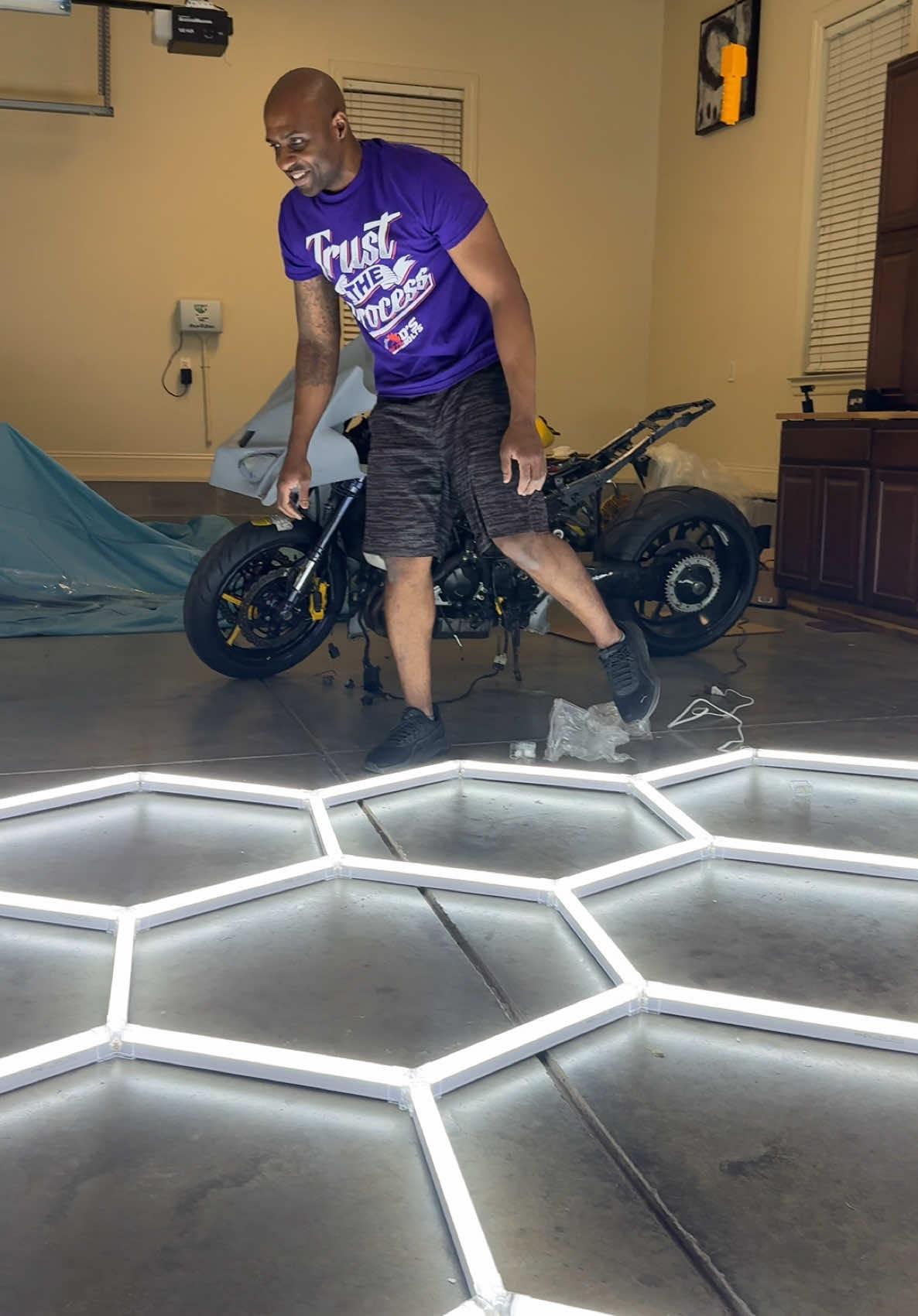 A post by @lifewithcarlos22 on TikTok caption: Turn any space into a masterpiece with this 14-piece hex light set. These modular LED panels snap together in any shape, letting you design your glow your way. Whether it’s for your garage, gaming room, or creative space—custom colors, dynamic effects, and sleek design make these lights the ultimate upgrade. ⸻ Hashtags: #HexLights, #LEDGlowUp, #CustomLighting, #HexWallPanels, #ModularLEDs, #GameRoomSetup, #GarageGoals, #CreativeLighting, #WallArtWithLight, #14HexLights, #SmartHomeVibes, #DIYLighting, #RGBSetup, #MoodLighting, #DesignYourGlow, #NextGenDecor, #FuturisticVibes, #LEDUpgrade, #SnapAndShine, #DsNutsAndBoltsStyle