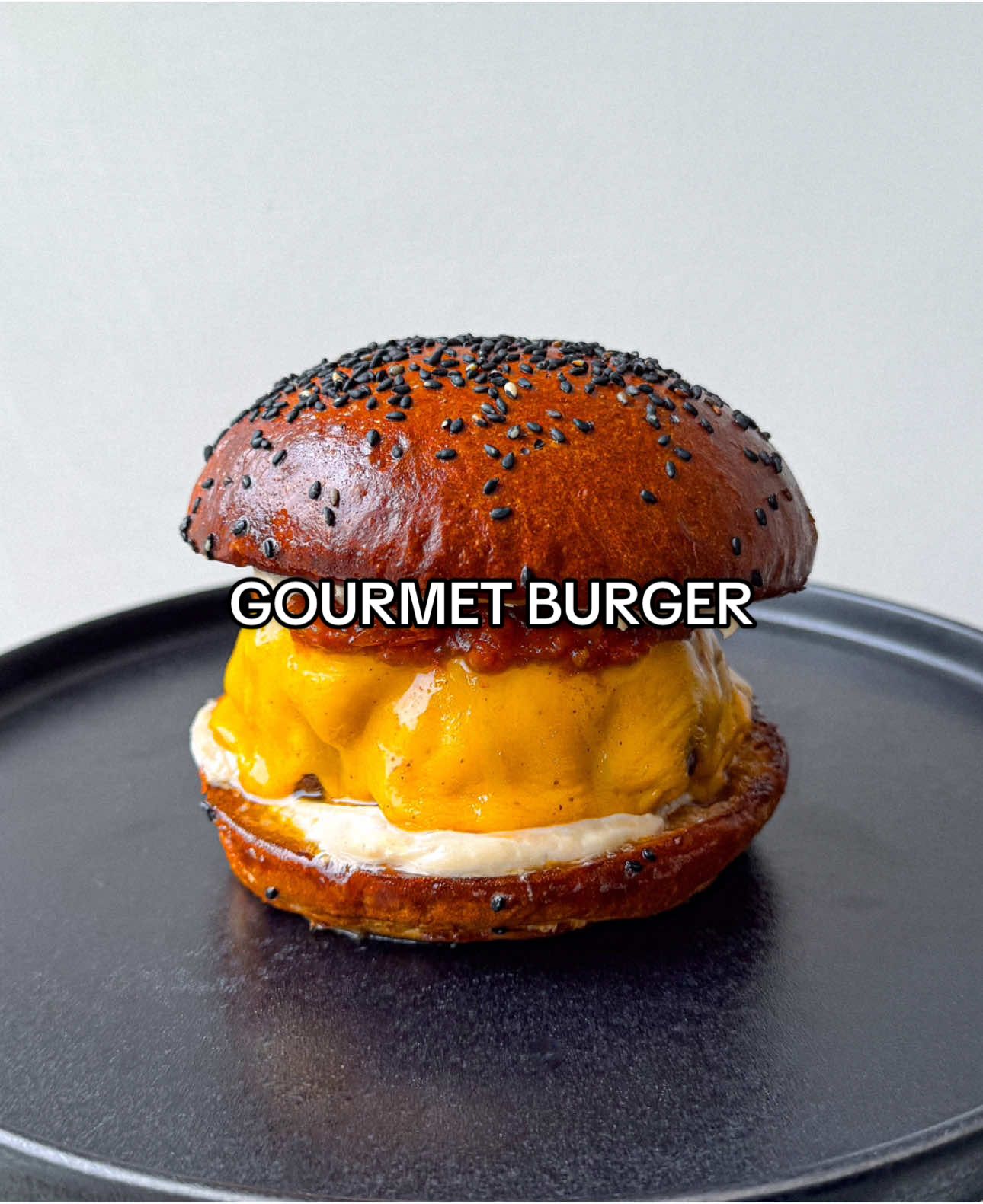 A post by @samseats on TikTok caption: Gourmet Burger 🍔 Full recipe now up on Substack - link in bio! 🔥❤️ #datenight #comfortfood #recipe #asmr #burger #bbq 