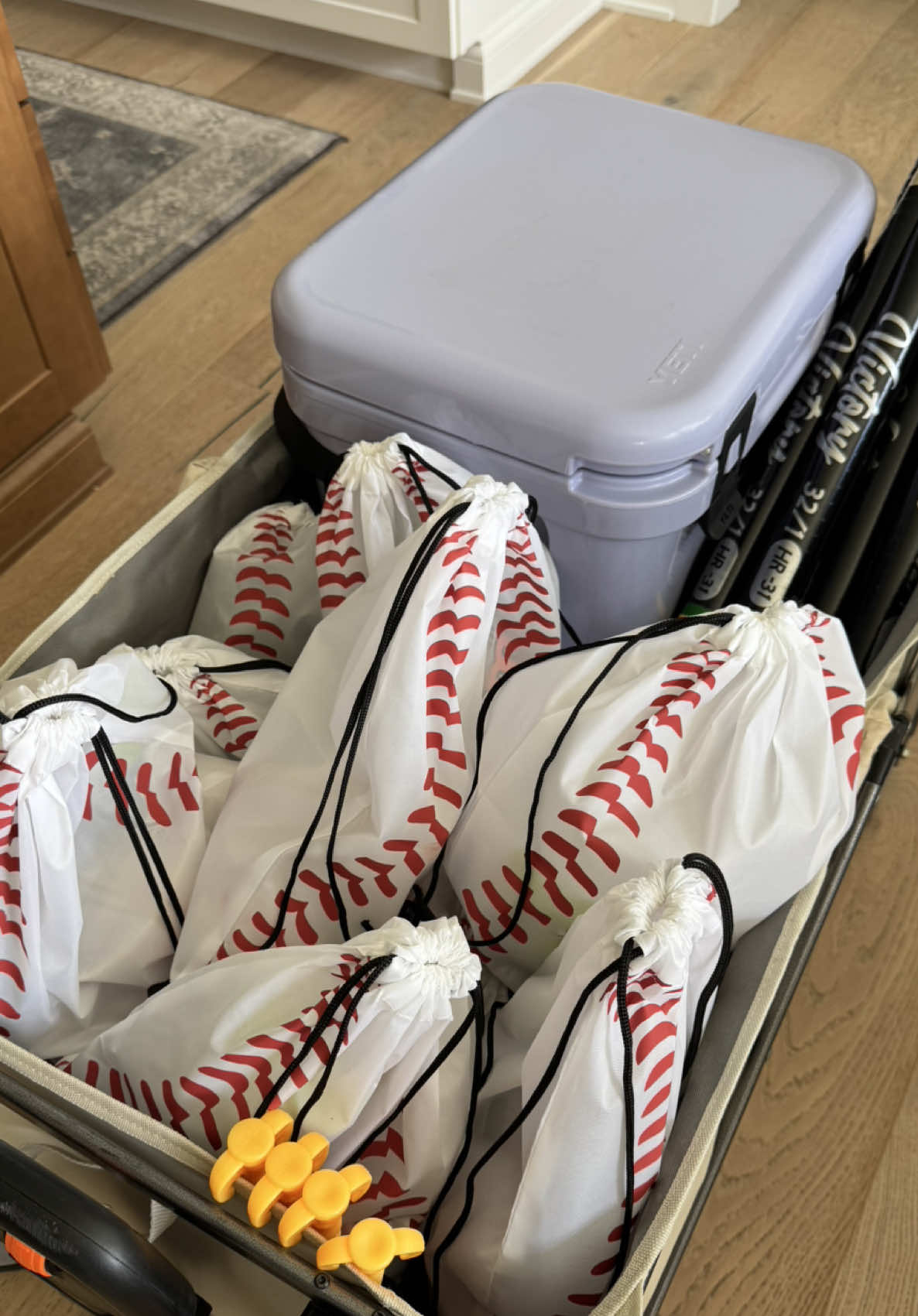 A post by @_catben_ on TikTok caption: Baseball goodie bags for my little homies☀️⚾️❤️🧢😎  #asmr #momlife #baseball #amazonfinds #swagbags #packwiithme #organizedhome #sportsnacks