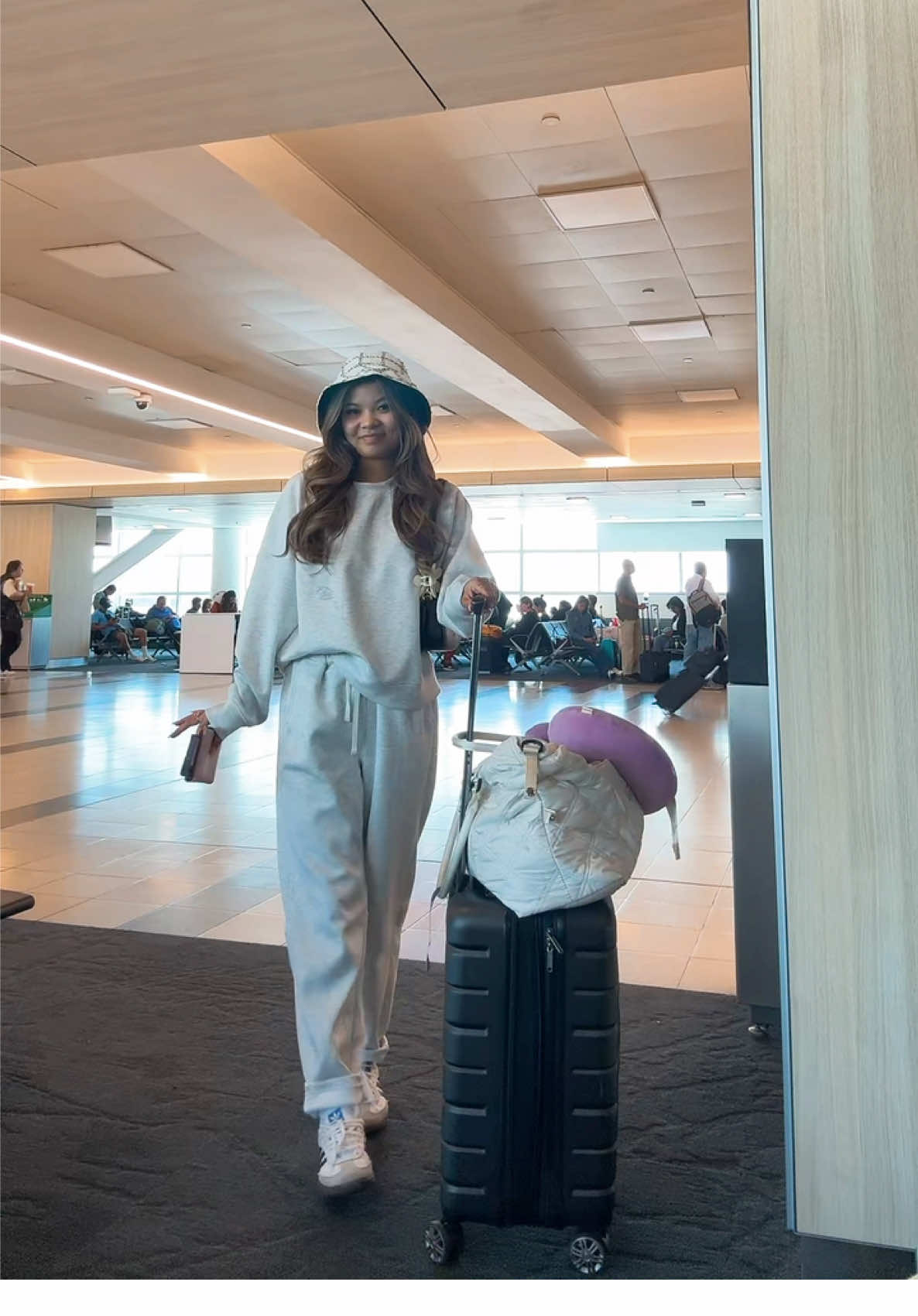 A post by @yoshna on TikTok caption: airport ootd for 20+ hrs travel 🫠🫠 #fyp #travel #honeymoon #ootd #airport #travel #thailand 