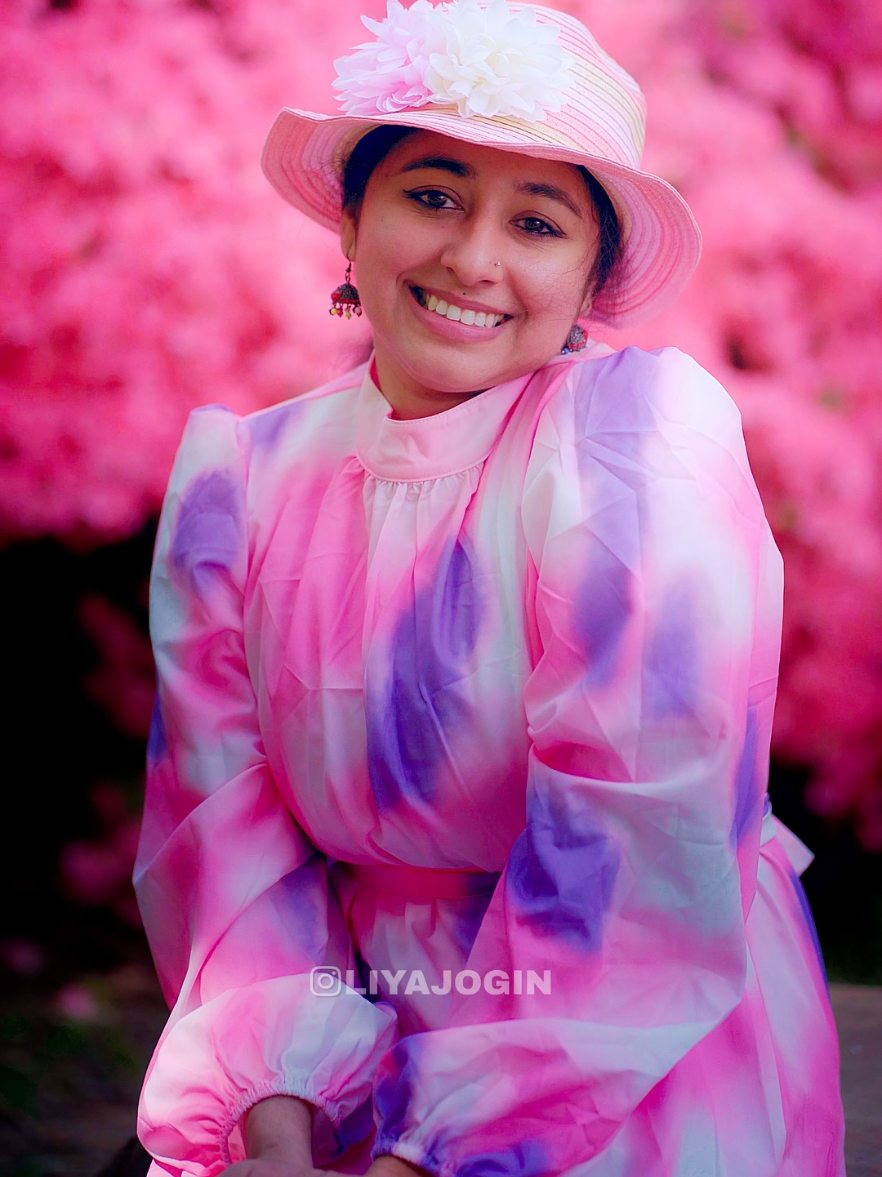 A post by @liyajogin on TikTok caption: പൂക്കാലം🌸📷 Jogin Mathew  . . .. . . . #90smalayalamsong #godfathersong #richmondpark #london #isabellaplantation #flowers #pink #poothumbee #pookalam #mukeshkanaka #trending #viral #joginmathew #liyajogin #malayalamhitsongs 