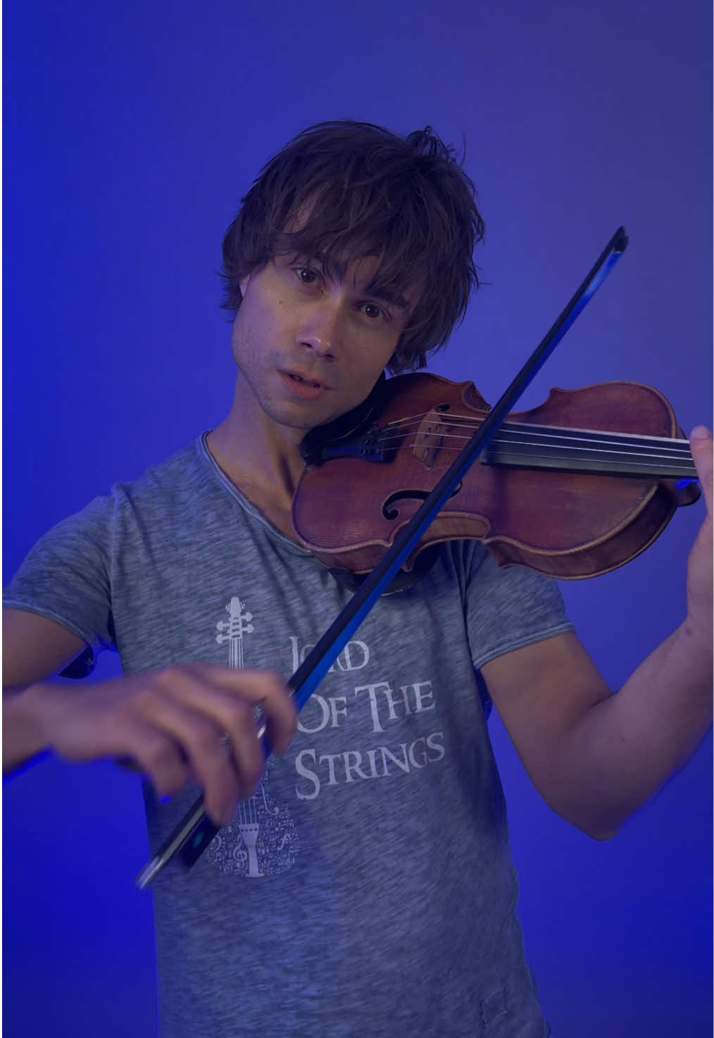 A post by @alexrybakofficial on TikTok caption: Red Sebastian + Blue Fairytale bow = PARTY 😎 Good luck Belgium! See you on tour in September (tickets in my bio). 🎻 And the fairytale bow can be found at Corusshop.com #strobelights #alexanderrybak #redsebastian #eurovision 