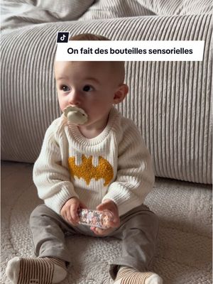 A post by @miiss_elina on TikTok caption: Pourquoi on achète des jouets déjà ? 🤔 #bebe #jeux #momlife #bouteille #maternite #drole 